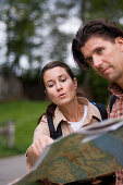 Couple looking at a map, Partnachklamm, Garmisch-Partenkirchen, Bavaria, Germany