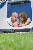 Senior couple lying in a tent