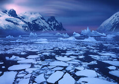 Ice floes near the Antarctic Circle with lenticularis cloud over mountain peak, Antarctic Peninsula,  Antarctica