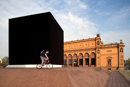 Cyclists near The Black Cube, Hamburg, Germany