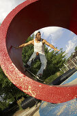 Skater skateboarding in tube at a skate park in Kansas City, Missouri, USA