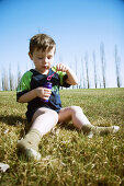 Young boy blowing bubbles in the park