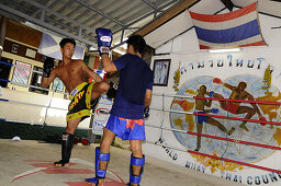 Two men Thai boxing in Khaosan district, Bangkok, Thailand