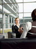 Two businesswomen having a meeting, Munich, Bavaria, Germany