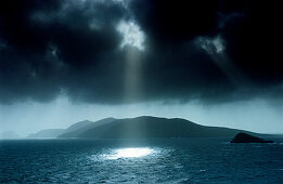 Sunbeams shining through dark cloud cover at Dingle Bay, Great Blasket Island, County Kerry, Ireland, Europe