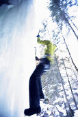 Ice climber on frozen waterfall, Immenstadt, Bavaria, Germany