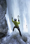 Ice climber on frozen waterfall, Immenstadt, Bavaria, Germany