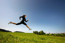 Woman jumping on meadow