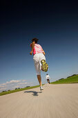 Couple jogging along road, Munsing, Bavaria, Germany