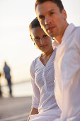 Mid adult couple in sunset, Ambach, Lake Starnberg, Bavaria, Germany