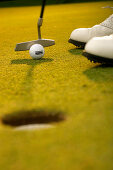 Golfer putting, Strasslach-Dingharting, Bavaria, Germany