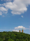 The towers of the Basilica ot the Fourteen Holy Helpers under white clouds, Franconia, Bavaria, Germany