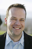 Mid adult man smiling at camera