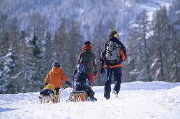 Family taking a walk in the ski resort of Motta Naluns above Scuol, Lower Engadine, Engadine, Switzerland