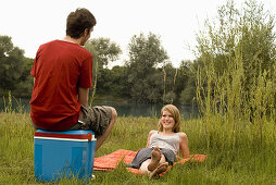Teenage couple at quarry pond, Freising, Bavaria, Germany