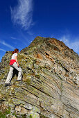 young woman on fixed rope route to Lazinser Rötelspitze, Spronser Seenplatte, Texelgruppe range, Ötztal range, South Tyrol, Italy