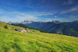alpine huts on alpine pasture Hodrawiesen, Dolomites with Geislergruppe and Sella range in background, Sarntaler Alpen, Sarntal range, South Tyrol, Italy