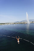 Man jumping from tower into the lake, Bains des Paquis, Geneva, Canton of Geneva, Switzerland