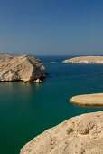 Deserted rocky coast under blue sky, Oman, Asia