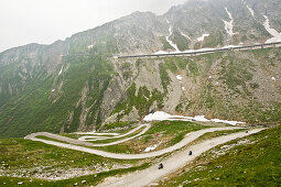 Three motorbikes on a mountain pass, Mountain landscape with tunnel, St. Gotthard, Switzerland