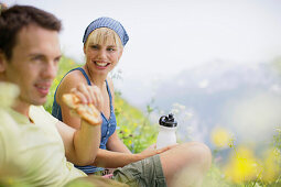 Young couple having a picnic, Werdenfelser Land, Bavaria, Germany