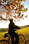 Woman alone outdoors on bicycle