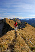 Woman hiking on trail at Fleischbank, Karwendel range, Tyrol, Austria