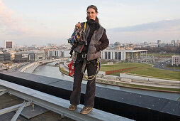 woman roof worker with equipment on central railway station, Berlin