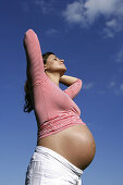 Pregnant woman stretching, Styria, Austria