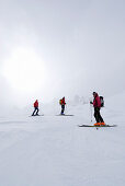 Skiers in diffus light, Cresta Bianca, Cristallo range, Dolomites, Veneto, Italy