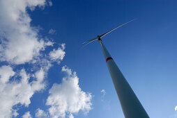 Wind turbine against blue sky with clouds, Bavaria, Germany
