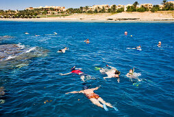 People snorkeling at the Lamaya Resort coral reef, Coraya, Marsa Alam, Red Sea, Egypt