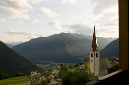 View from the balcony of Hotel Moosmair towards church Ahornach, Sand in Taufers, South Tyrol, Italy