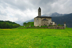 Church in Rossura situated in a meadow, valley Leventina, Ticino, Switzerland