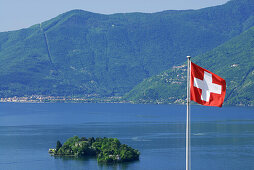 Flag of Switzerland in front of isle of Brissago, Isole di Brissago, in lake Maggiore, lake Maggiore, Lago Maggiore, Ticino, Switzerland