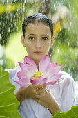 17-19, Beauty, Body care, Casual, Caucasian, Clothing, Color, Colour, Contemporary, Flower, Fragility, Freshness, Green, Head & shoulders, Head and shoulders, Health, Holding, Leaf, Looking at camera, Lotus, One person, Outdoors, Pink, Portrait, Rain, Sho