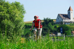 Female cyclist, St. Nicholas' Church, Danube Cycle Route Passau Vienna, Lower Austria, Austria