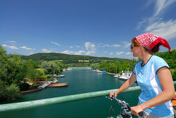 Female cyclist on bridge over river Erlauf, Danube Cycle Route Passau Vienna, Poechlarn, Wachau, Lower Austria, Austria