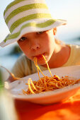 Girl eating spaghetti, Formentera, Balearic Islands, Spain