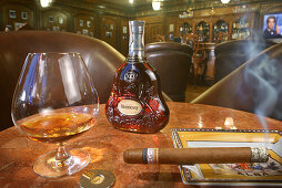 A glass of whiskey and a smoking cigar at the cigar lounge at Peacock Garden resort, Baclayon, Bohol, Philippines, Asia