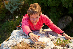 Middle-aged woman climbing, Sassari province, Sardinia, Italy, Europe