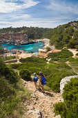 Mother and daughter hiking to the bay Cala s'Almonia, Mallorca, Balearic Islands, Mediterranean Sea, Spain, Europe