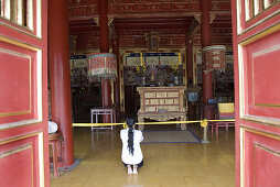 Praying woman at a temple, forbidden Purple City in the imperial town of Hue, Thua Thien-Hue Province, Vietnam, Asia
