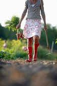 Mature woman in a vegetable garden, Lower Saxony, Germany