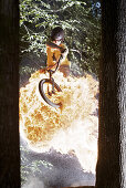 BMX bike rider jumping through fireball, Mindelheim, Bavaria, Germany