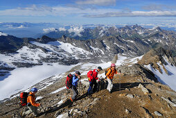 Four mountain hikers ascending to mount Hochfeiler, Zillertal Alps, South Tyrol, Italy