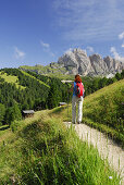 Woman hiking, Geisler range, Dolomites, Trentino-Alto Adige/South Tyrol, Italy
