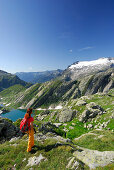 Female hiker looking to Basodino glacier, Ticino Alps, Ticino, Switzerland