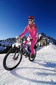 Snow biking, Chiemgau, Bavaria, Germany