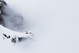 Mountain lodge Cabane de l'A Neuve in fog, Val Ferret, Canton of Valais, Switzerland